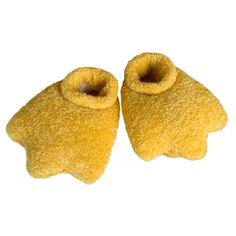 pair of yellow slippers on white background