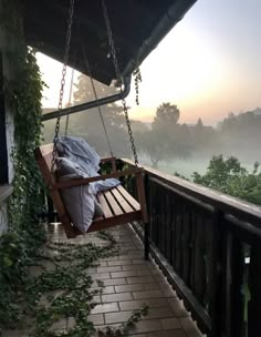 a wooden swing hanging from the side of a building