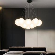 a living room filled with furniture and a chandelier hanging over the top of it