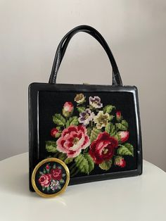 Vintage 1950s floral embroidery handbag  with a matching embroidery compact. The inside of the bag is lined in suede leather and there are four inner pockets.   ★ Measurements: H: 9.5 "  and W : 11.5" ★ Label/Designer: n/a ★ Condition: excellent Shipping Is Avaliable Worldwide. Every item is carefully shipped Priority via Air Mail - shipping takes from 7 to 14 working days, depending on your location. Shipping includes Tracking. Come and check out our shop to see all items! https://www.etsy.com/ Embroidered Rectangular Bag For Vintage Events, Embroidered Rectangular Bags For Vintage Events, Rectangular Embroidered Bags For Vintage Events, Vintage Bags With Floral Embroidery For Daily Use, Vintage Formal Bag With Floral Embroidery, Vintage Floral Embroidered Bag For Formal Occasions, Vintage Floral Embroidery Bags For Formal Occasions, Vintage Embroidered Top Handle Shoulder Bag, Vintage Floral Embroidery Formal Bags