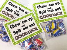 three bags of candy sitting on top of a white table next to eachother