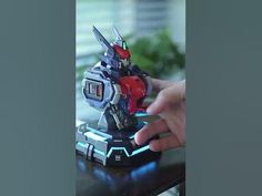 a hand is holding a toy that looks like a robot from the movie's upcoming film