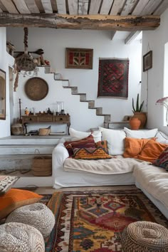 a living room filled with lots of furniture and rugs on top of a floor