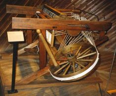 an old spinning wheel on display in a museum