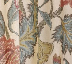 an image of a curtain with flowers and leaves on it's side, close up