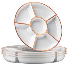 four white dishes stacked on top of each other with copper rims and plates in the middle