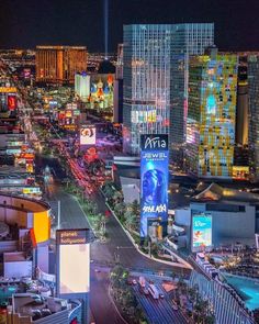 an aerial view of the las vegas strip at night with neon lights and skyscrapers