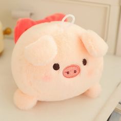 a small stuffed pig sitting on top of a counter