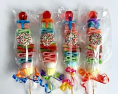 candy lollipops wrapped in cellophane and decorated with colorful sprinkles