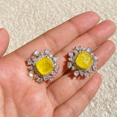 Fancy Yellow Diamond Earrings featuring semi precious yellow stone surrounded with cz diamonds. Ideal to pair with your formals and statement look. These PREMIUM QIUALITY Yellow CZ Earrings are surely elevate your look and give you a LUXURY look. Perfect gift for Her *𝐏𝐑𝐎𝐃𝐔𝐂𝐓 𝐃𝐄𝐓𝐀𝐈𝐋* * 𝐌𝐚𝐭𝐞𝐫𝐢𝐚𝐥: Brass * 𝐏𝐥𝐚𝐭𝐢𝐧𝐠: White Rhodium Plated * 𝐒𝐭𝐨𝐧𝐞: AAA-quality CZ Yellow Diamond. 𝐕𝐢𝐬𝐢𝐭 𝐎𝐮𝐫 𝐅𝐀𝐐𝐬 𝐟𝐨𝐫 𝐒𝐡𝐢𝐩𝐩𝐢𝐧𝐠 𝐏𝐨𝐥𝐢𝐜𝐢𝐞𝐬 𝐚𝐧𝐝 𝐂𝐚𝐫𝐞 𝐈𝐧𝐬𝐭𝐫𝐮𝐜𝐭𝐢𝐨𝐧 *𝐃𝐈𝐒𝐂𝐋𝐀𝐈𝐌𝐄𝐑* * Product color may slightly vary due to photographic lighting sources or your screen settings. * Stone color may vary slightly due to variations in natural stones. *𝐒𝐈𝐌𝐈𝐋𝐀𝐑 𝐃𝐄𝐒𝐈𝐆𝐍* https://www.etsy.com/listing/1733573690/ Yellow Diamond Earrings, Yellow Diamond Earring, Bride Wedding Gift, Earrings Bride, Earrings Luxury, Fancy Yellow Diamond, Wedding Gifts For Bride, Yellow Stone, Cz Earrings