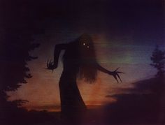 a woman standing in the dark with her arms outstretched and hands extended out, looking down at trees