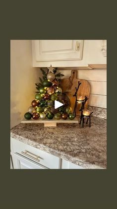 a kitchen counter top with a christmas tree on it