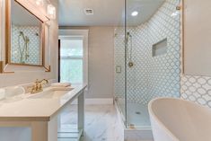 a bathroom with a tub, sink and shower