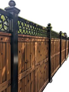 a wooden fence with wrought iron work on it's top and bottom panels, along with a lamp post