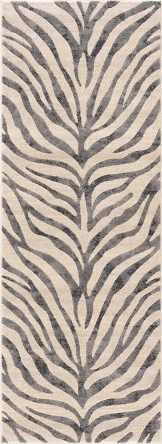 a rug with zebra print on it in grey and white colors, the area is very soft