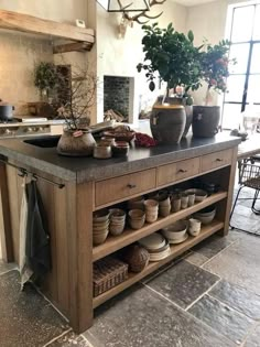 a kitchen island with pots and pans on it