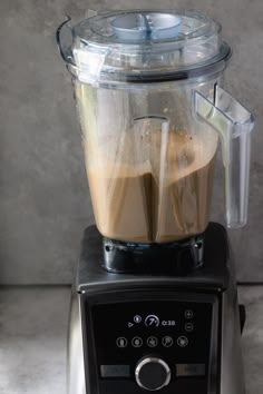 a blender filled with liquid sitting on top of a counter