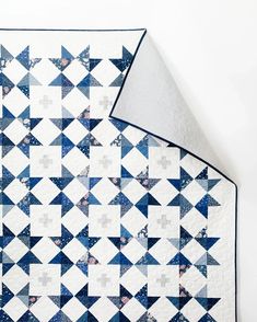 a blue and white quilt with stars on it