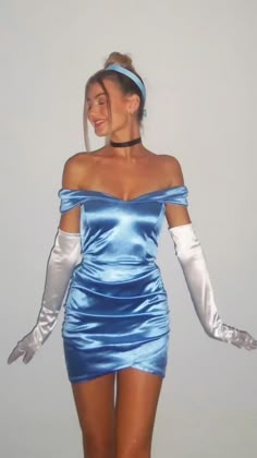 a woman in a blue dress and white gloves