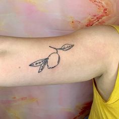 a woman's arm with a small tattoo on the left side of her arm