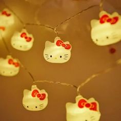 hello kitty string lights are hanging from the ceiling and decorated with red bows on them