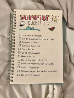 a summer bucket list on top of a bed