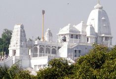 a large white building surrounded by trees