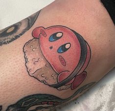 a close up of a person's arm with a tattoo on it that has an image of a piece of food in the middle