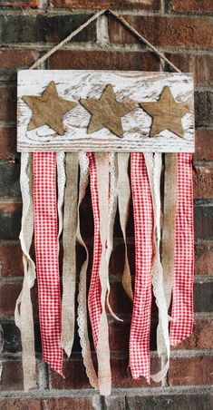 an american flag made out of burlocks hanging on the side of a brick wall