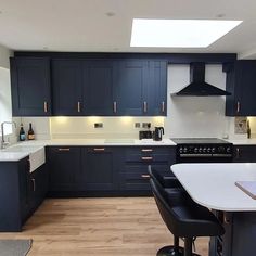 a kitchen with blue cabinets and white counter tops