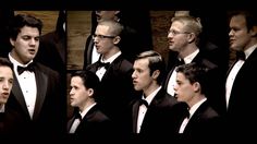 a group of men in tuxedos standing next to each other with their mouths open