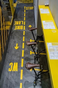 there are three bikes parked on the bike lane in this building, and one is empty