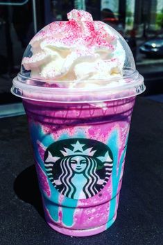 a starbucks drink with whipped cream and sprinkles