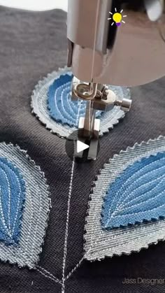 a close up of a sewing machine working on a piece of fabric that has been stitched together