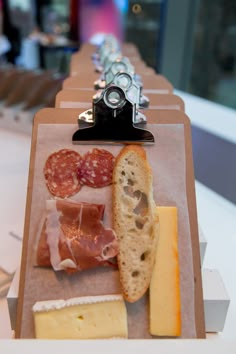 a variety of cheeses and meats are on display