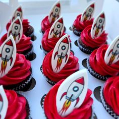 cupcakes with red frosting decorated like rockets