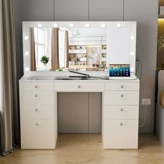 a white vanity with lights on it in a room