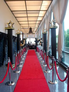 a red carpet is lined up between two black pillars