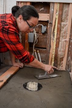 a woman working on an unfinished piece of wood