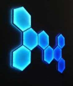 the blue hexagons are glowing against a black background