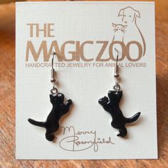 "These enamel black cat earrings make a fantastic gift for the cat lover! Do you happen to think black cats bring good luck! I do, and why not? These handcrafted and hand painted earrings are each 1\" tall by 3/8\" wide and come on stainless steel ear wires. By the way, they would be wonderful to wear on Halloween! When I create a pair of enamel earrings, they are usually created mirror-image style, with the right and left earring facing each other. Because of the hand crafted nature of my work, Black Novelty Jewelry For Gifts, Novelty Black Cat Design Jewelry, Black Cat Design Novelty Jewelry, Novelty Black Jewelry With Cat Design, Black Novelty Jewelry With Cat Design, Black Cat Ears Jewelry With Cat Design, Black Cat Ears Jewelry For Gifts, Black Cat Ears Jewelry As A Gift, Novelty Black Earrings For Gift