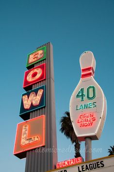 a bowling alley sign and neon bowling ball signs