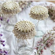 crocheted doily in glass jars with lavender flowers on the table behind them