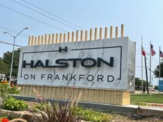 the sign for halston on franklin rd in front of an american flag and flowers