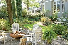 two adiron chairs sitting around a fire pit