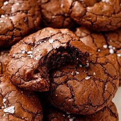 a pile of chocolate cookies with sea salt on top