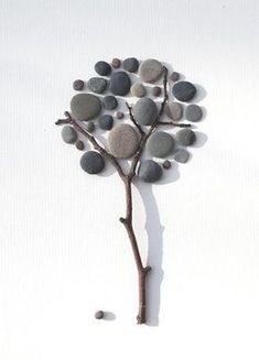 a tree made out of rocks with the word joy written below it and an image of a butterfly on top