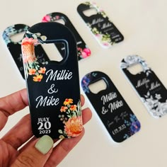 a person holding up a phone case with flowers on it and the name of their wedding date