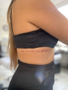 the back of a woman's stomach with writing on it