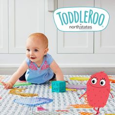 a baby laying on the floor with toys in front of it and toddleroo north states logo